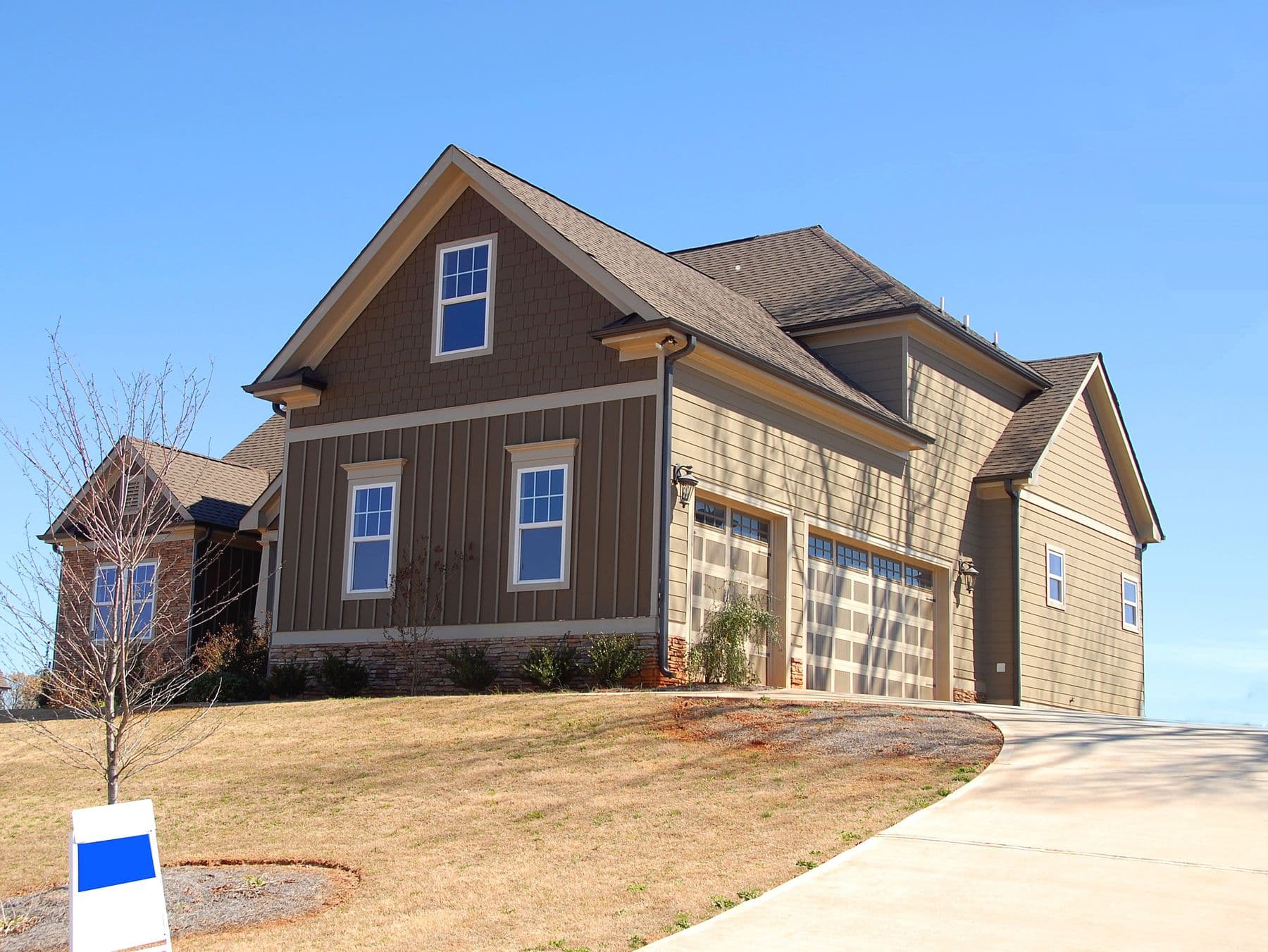 A suburban craftsman home with shake gables and board-and-batten siding